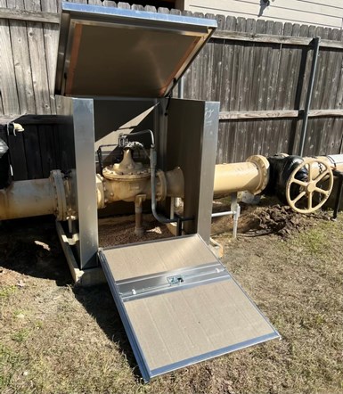 Photo of large aluminum box (with front and top panels open) protecting control valve.