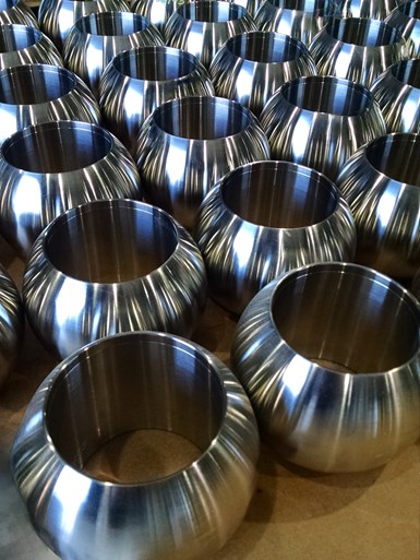 A table with more than a dozen chrome carbide plated balls for ball valves